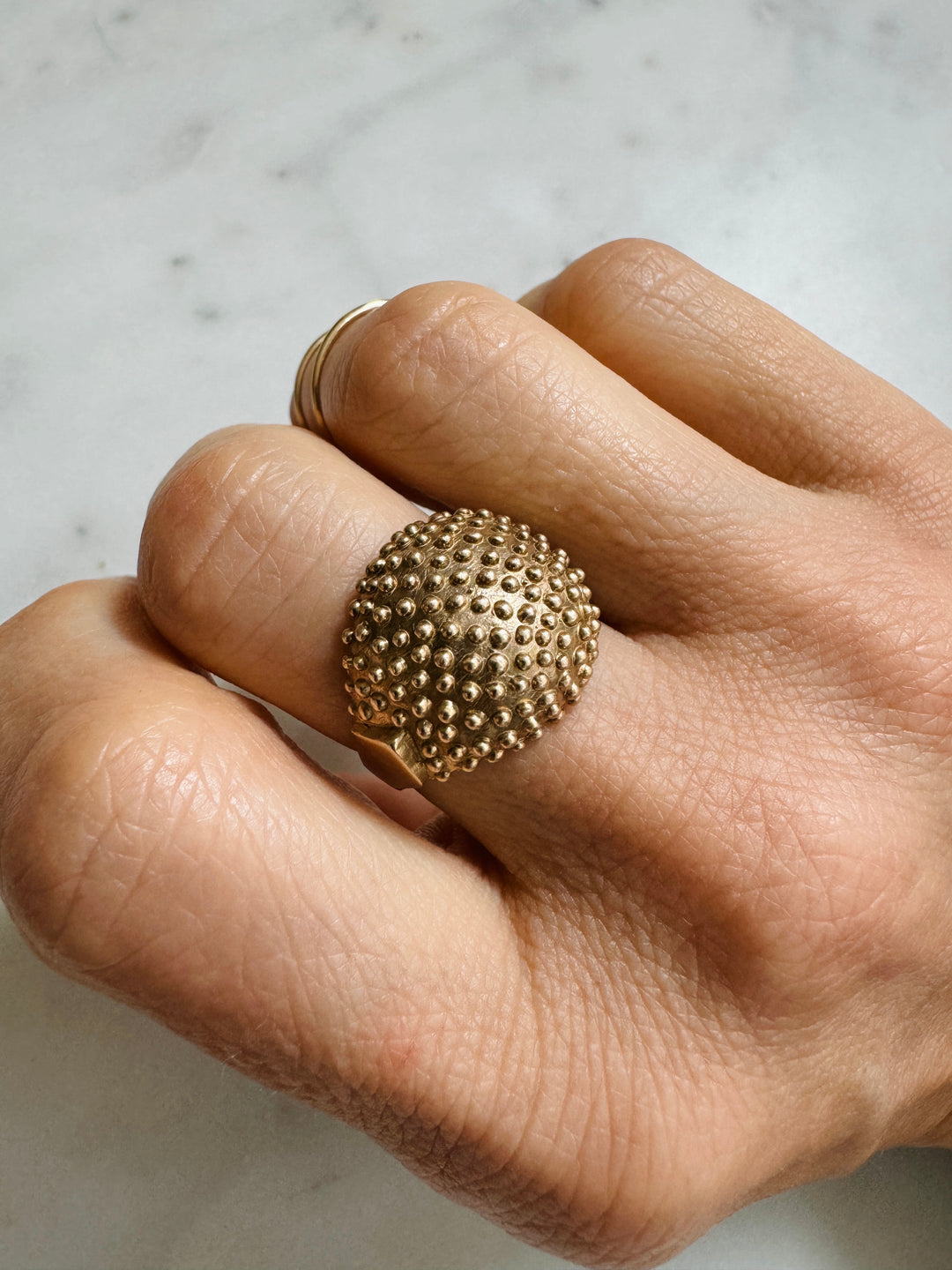 Woman Wears the MIMOSA Handcrafted Mock Strawberry Ring in Bronze