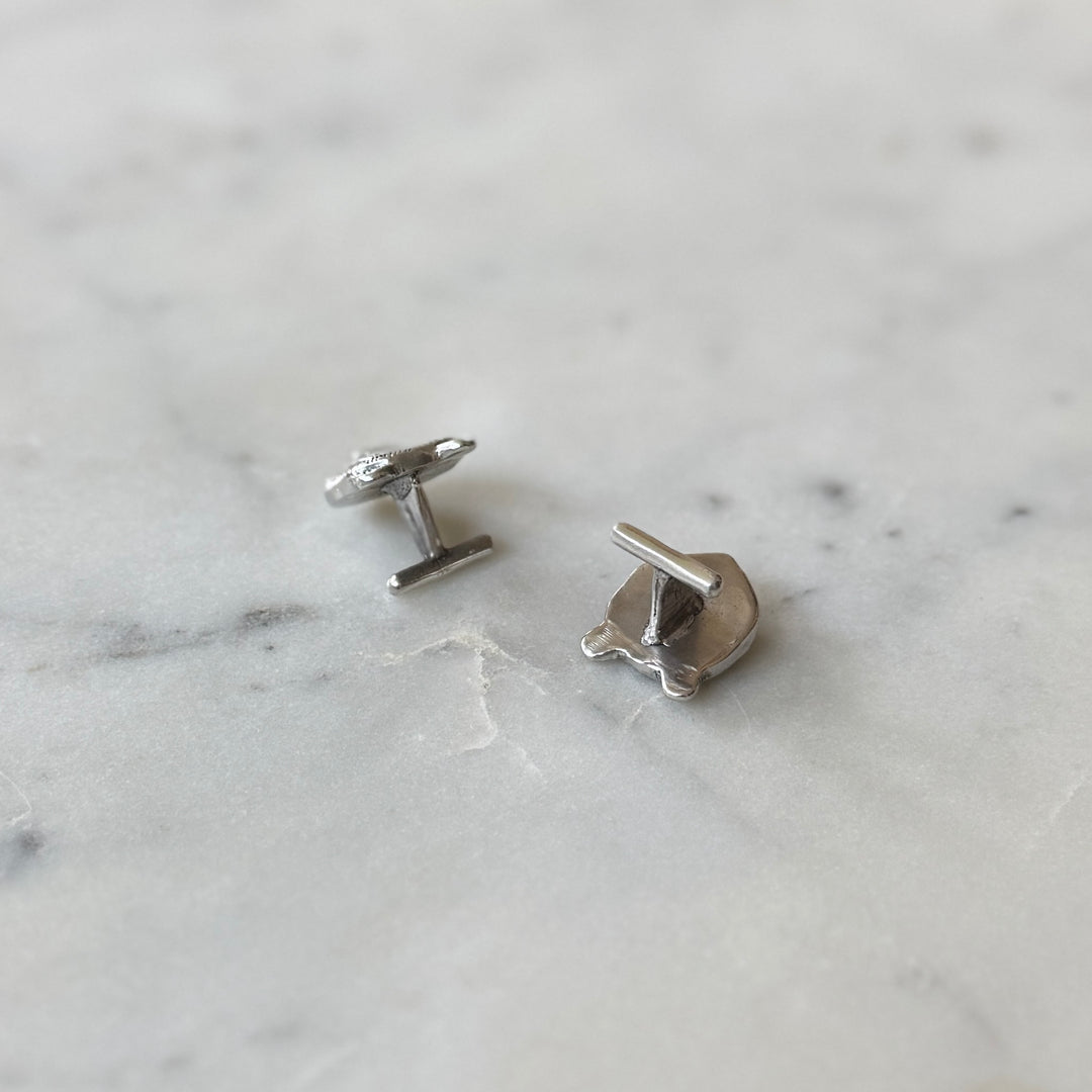 Sterling Silver Cufflinks on a Marble Surface