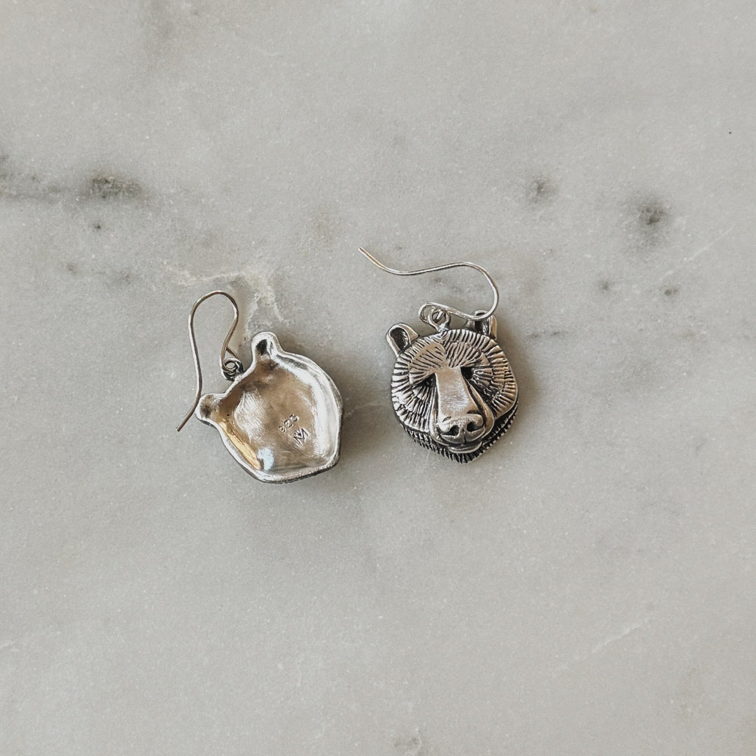 Sterling Silver Bear Head Shaped Earrings on Marble Surface