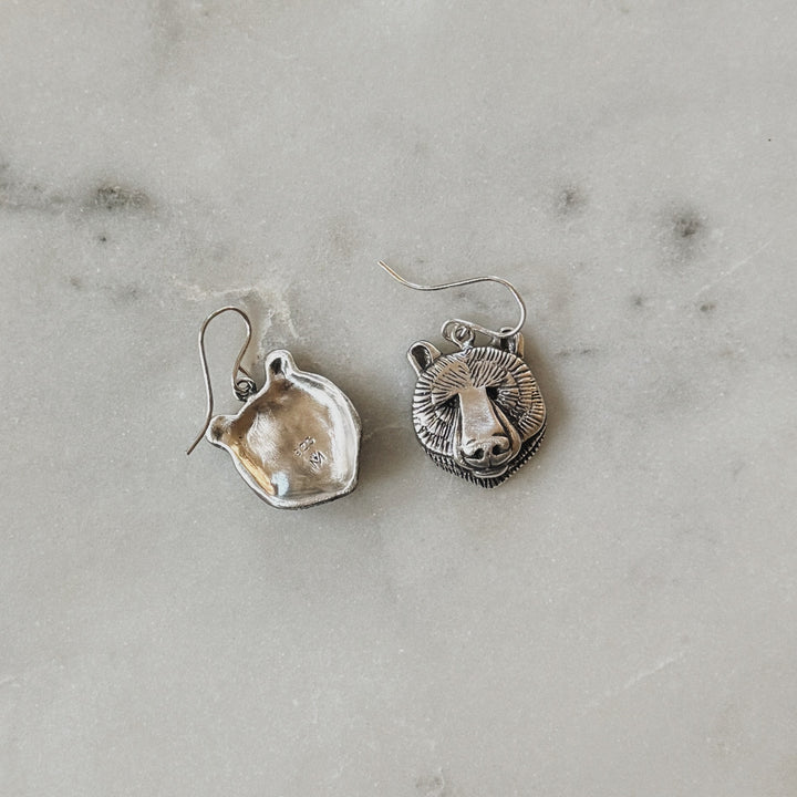 Sterling Silver Bear Head Shaped Earrings on Marble Surface