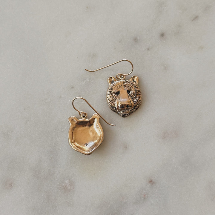 Bronze Bear Head Shaped Earrings on Marble Surface