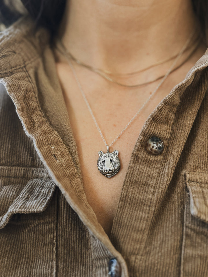 Close-Up of a Person Wearing a Sterling Silver Bear Head Pendant