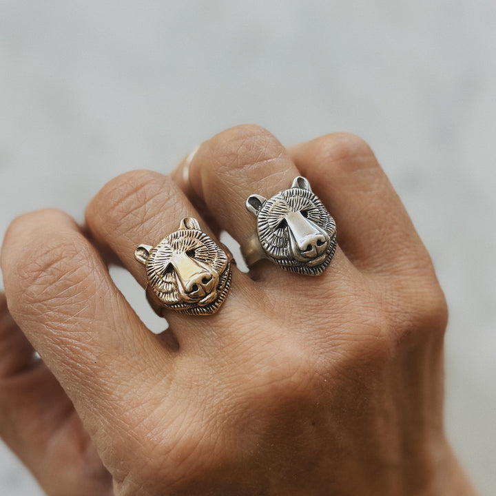 Hand Wears Bear Head Rings in Bronze and Sterling Silver