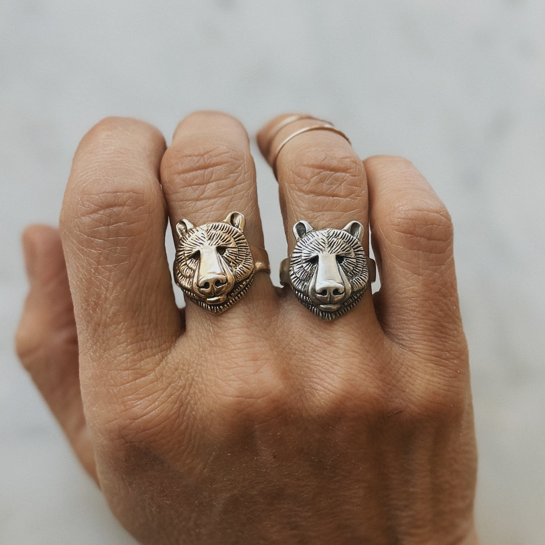 Hand Wearing Bear Head Rings in Bronze and Sterling Silver
