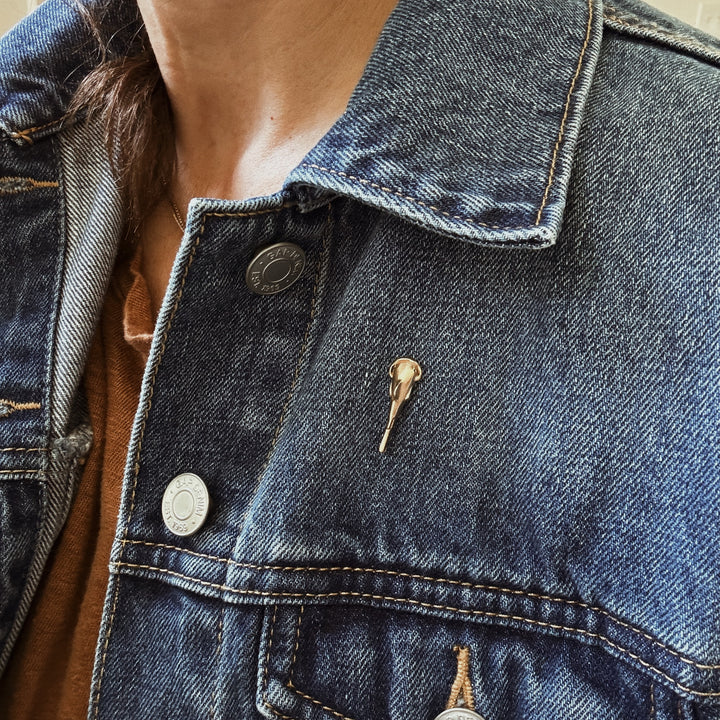 Person Wears the MIMOSA Handcrafted Catfish Pin