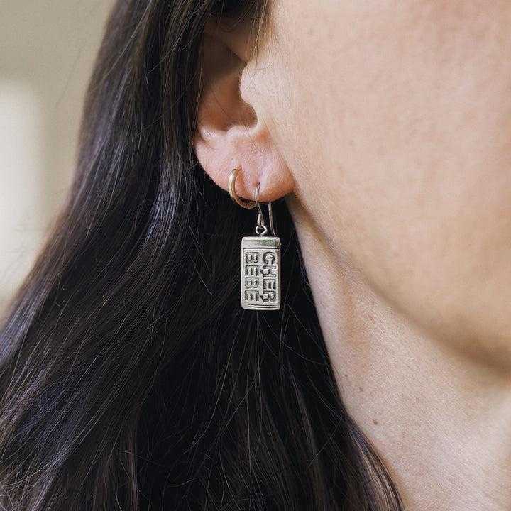 Person wears Sterling Silver Cher Bebe Earrings from MIMOSA Handcrafted