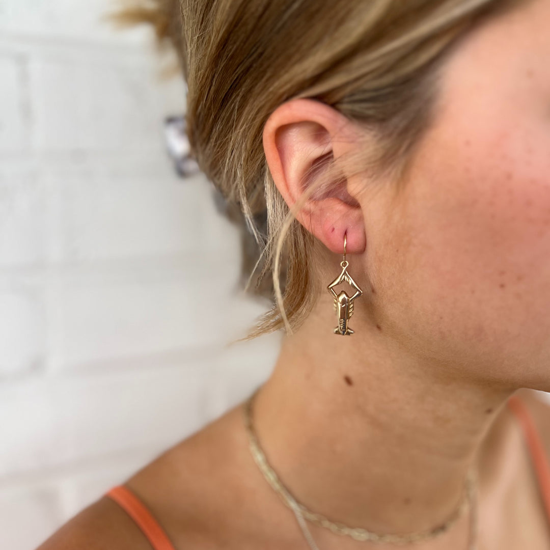 Woman Wears MIMOSA Handcrafted Crawfish Earrings in Bronze.