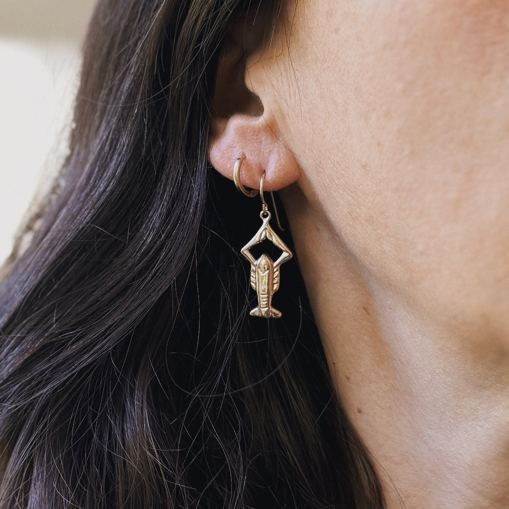 Person wears Bronze Crawfish Earrings from MIMOSA Handcrafted