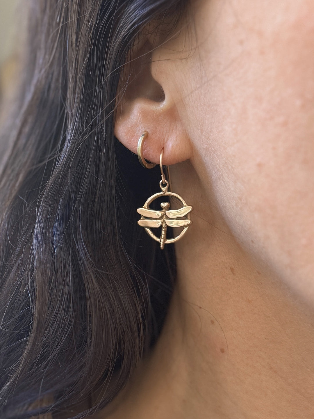Woman Wears Dragonfly Earrings in Bronze