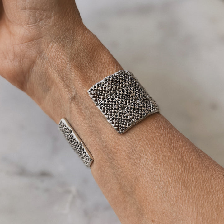 Person wears handmade 3-row granny square bracelet in sterling silver by MIMOSA Handcrafted