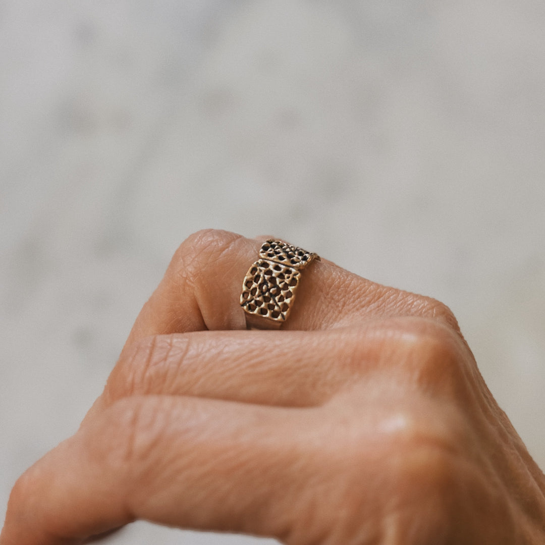 Person wears a handmade granny square ring in bronze by MIMOSA Handcrafted