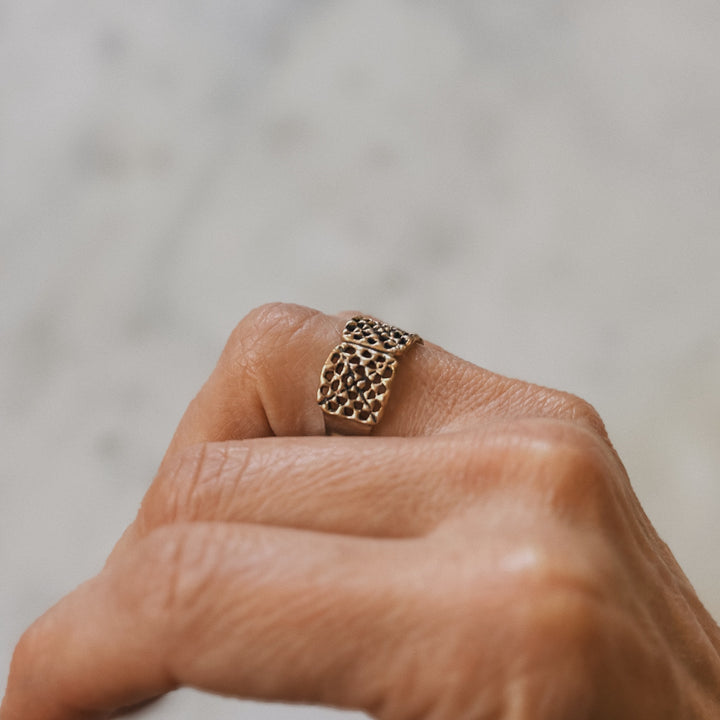 Person wears a handmade granny square ring in bronze by MIMOSA Handcrafted
