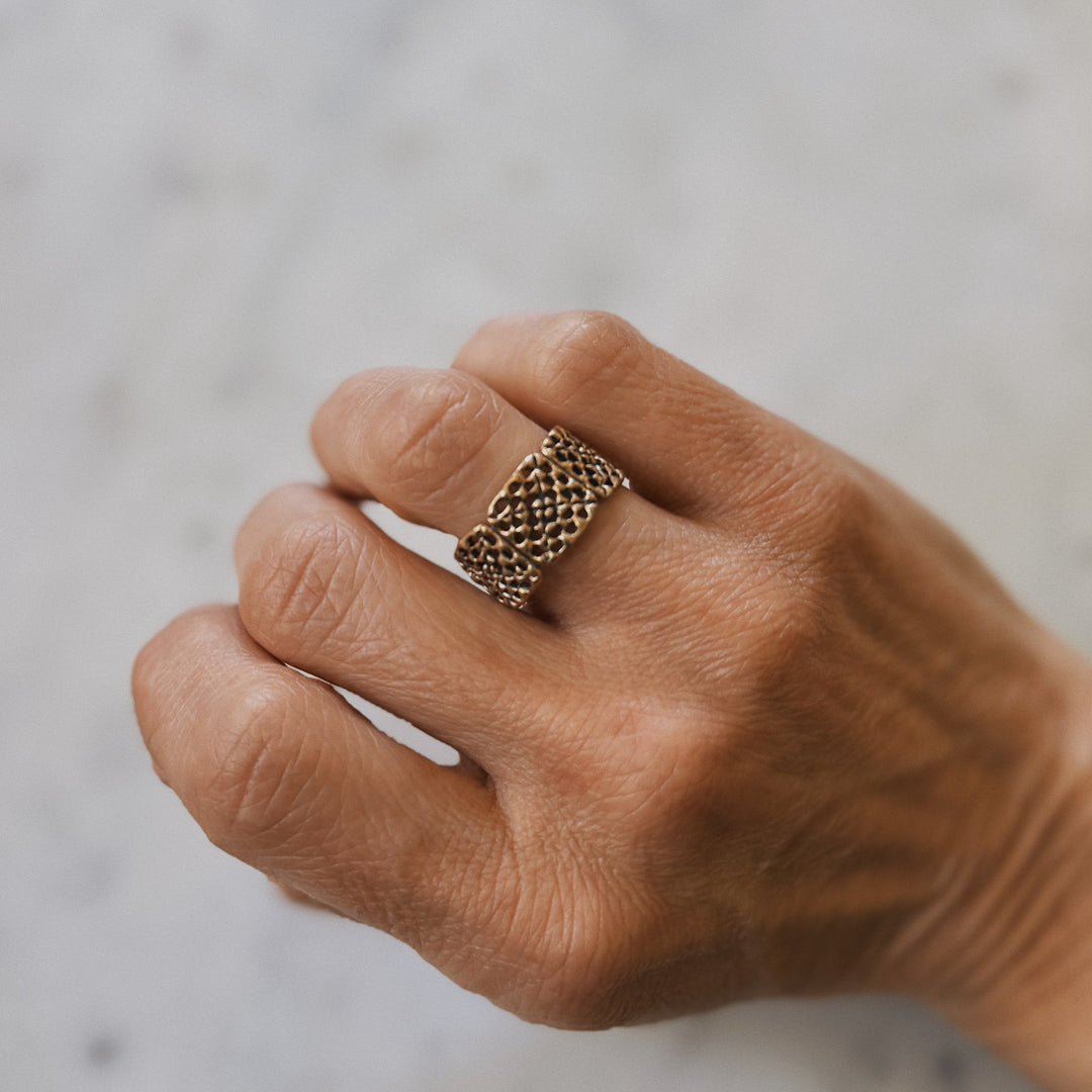 Person wears a handmade granny square ring in bronze by MIMOSA Handcrafted