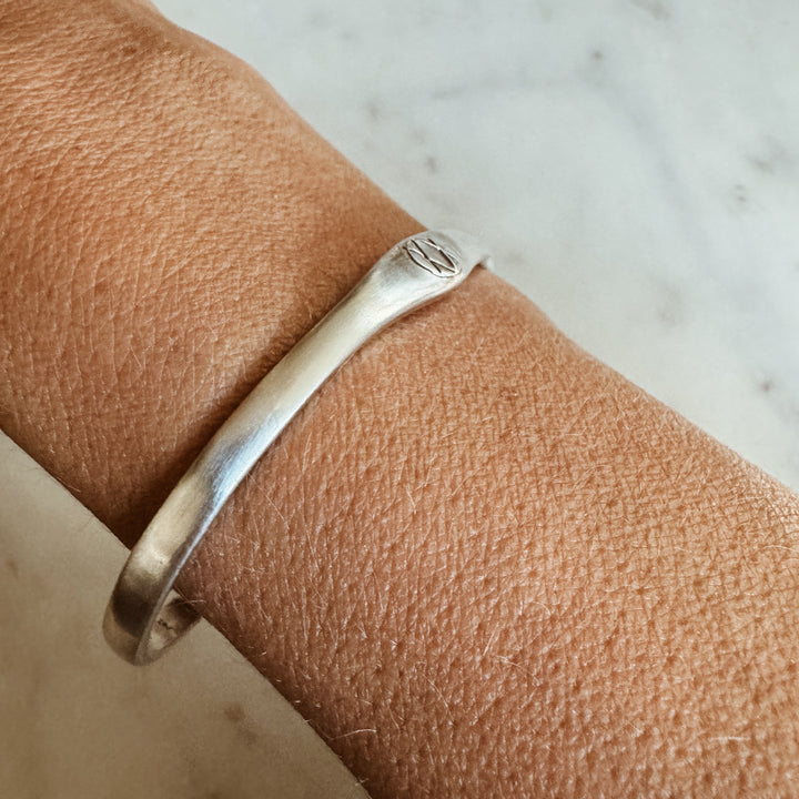 Woman Wears the MIMOSA Handcrafted Joy and Sorrow Cuff in Sterling Silver