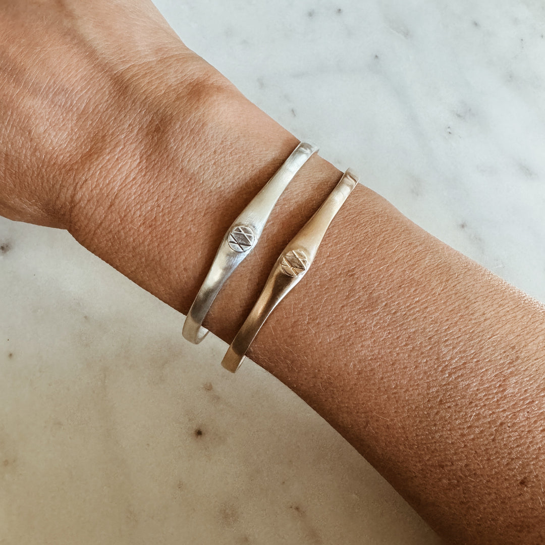 Woman Wears the MIMOSA Handcrafted Joy and Sorrow Cuff in Sterling Silver and Bronze