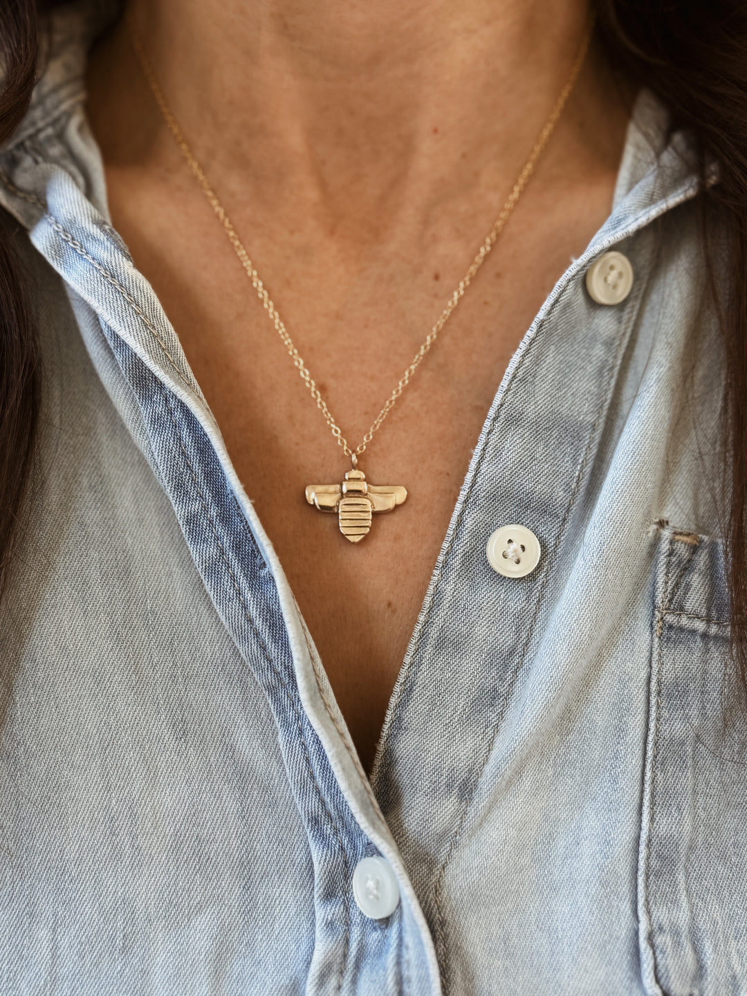 Woman Wears the Large MIMOSA Handcrafted Bee Pendant in Bronze