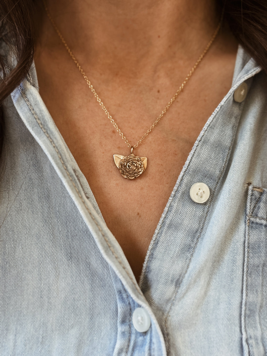 Woman Wears the Large MIMOSA Handcrafted Camellia Pendant in Bronze