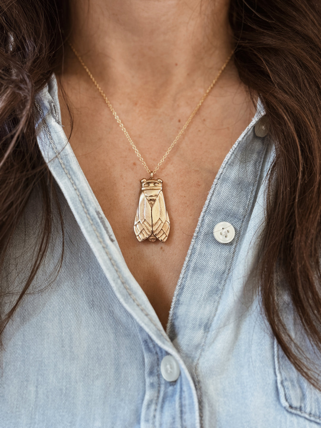 Woman Wears the Large MIMOSA Handcrafted Cicada Pendant in Bronze