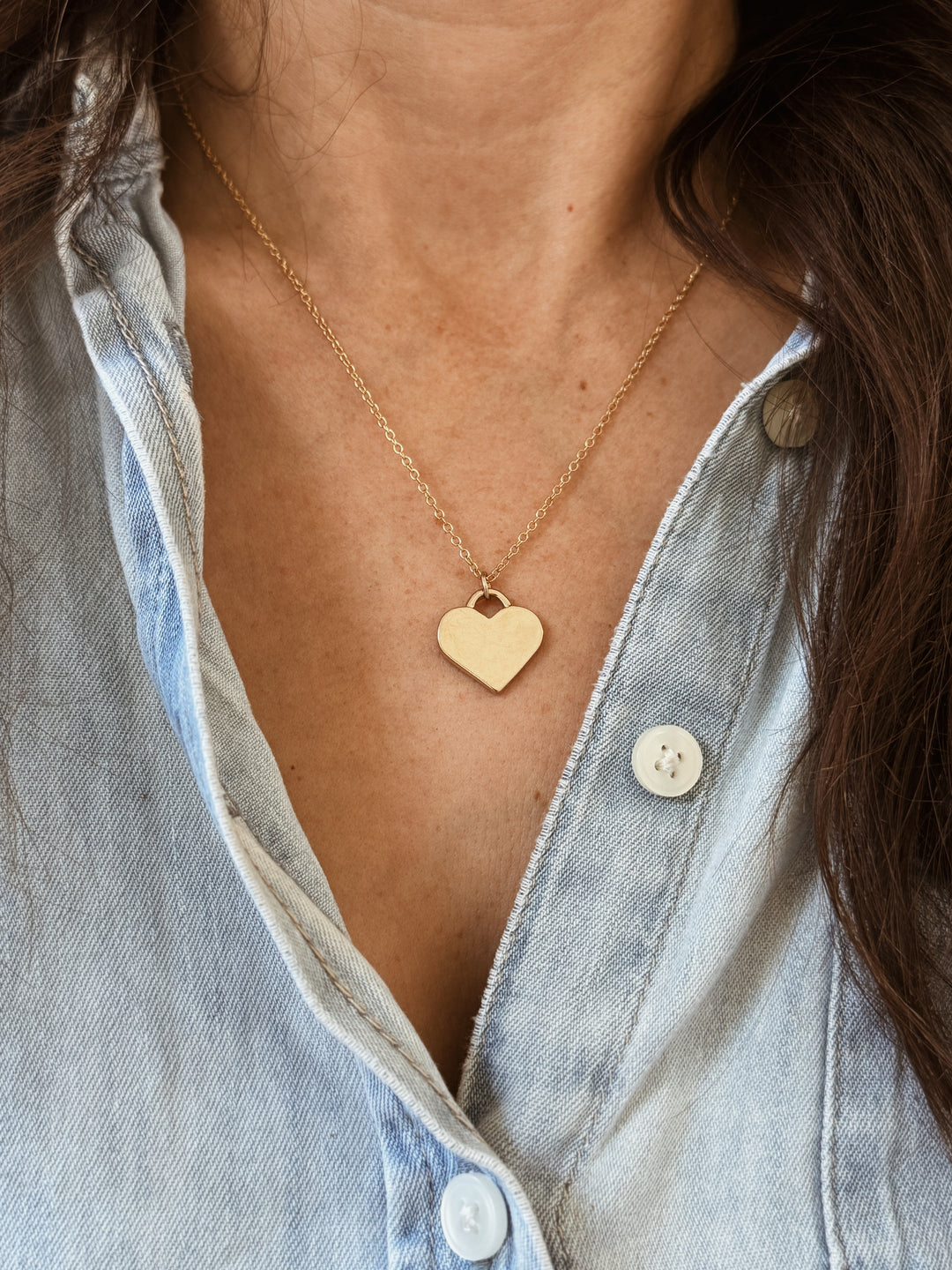 Woman Wears the Large MIMOSA Handcrafted Heart Pendant in Bronze