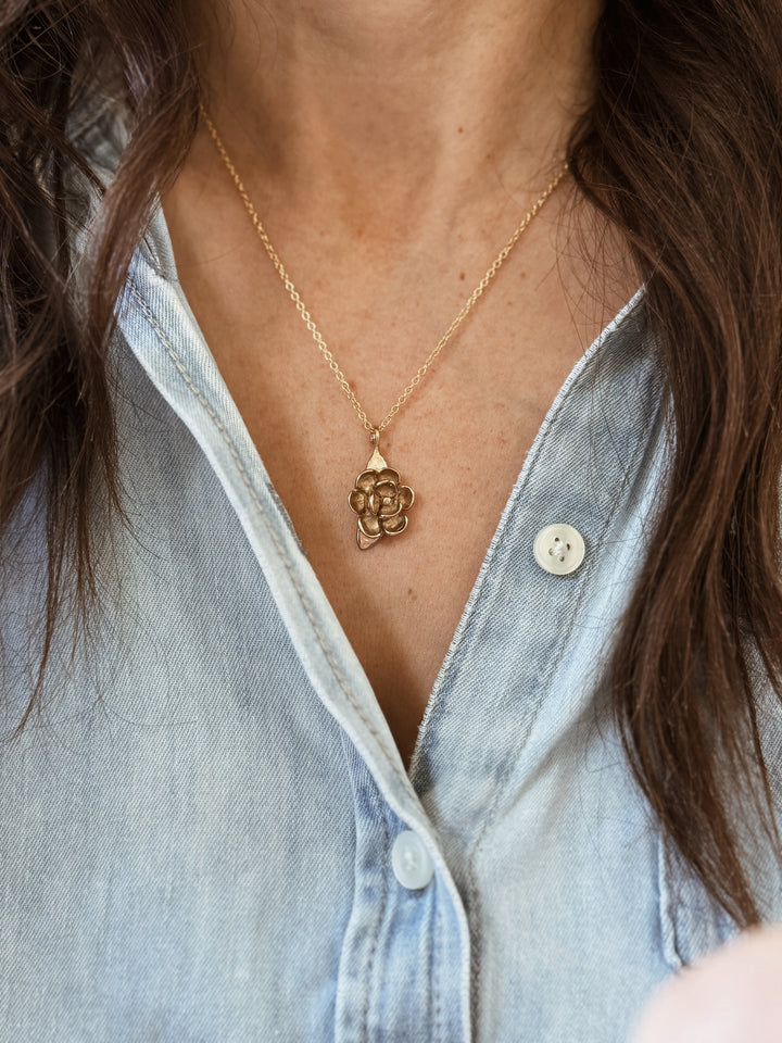 Woman Wears the Large MIMOSA Handcrafted Magnolia Pendant in Bronze