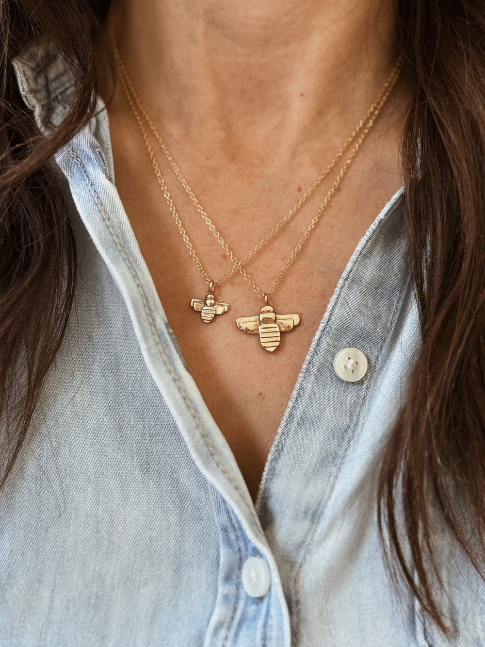 Woman Wears the MIMOSA Handcrafted Large and Small Bee Pendants in Bronze