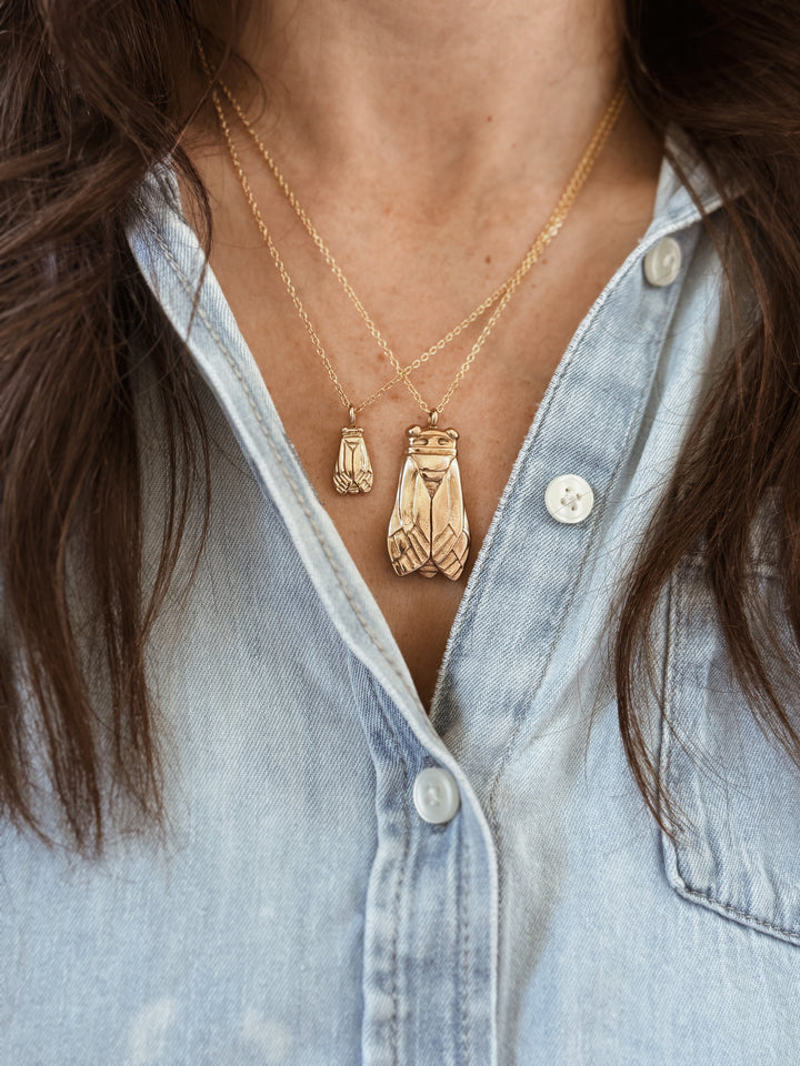 Woman Wears the MIMOSA Handcrafted Large and Small Cicada Pendants in Bronze