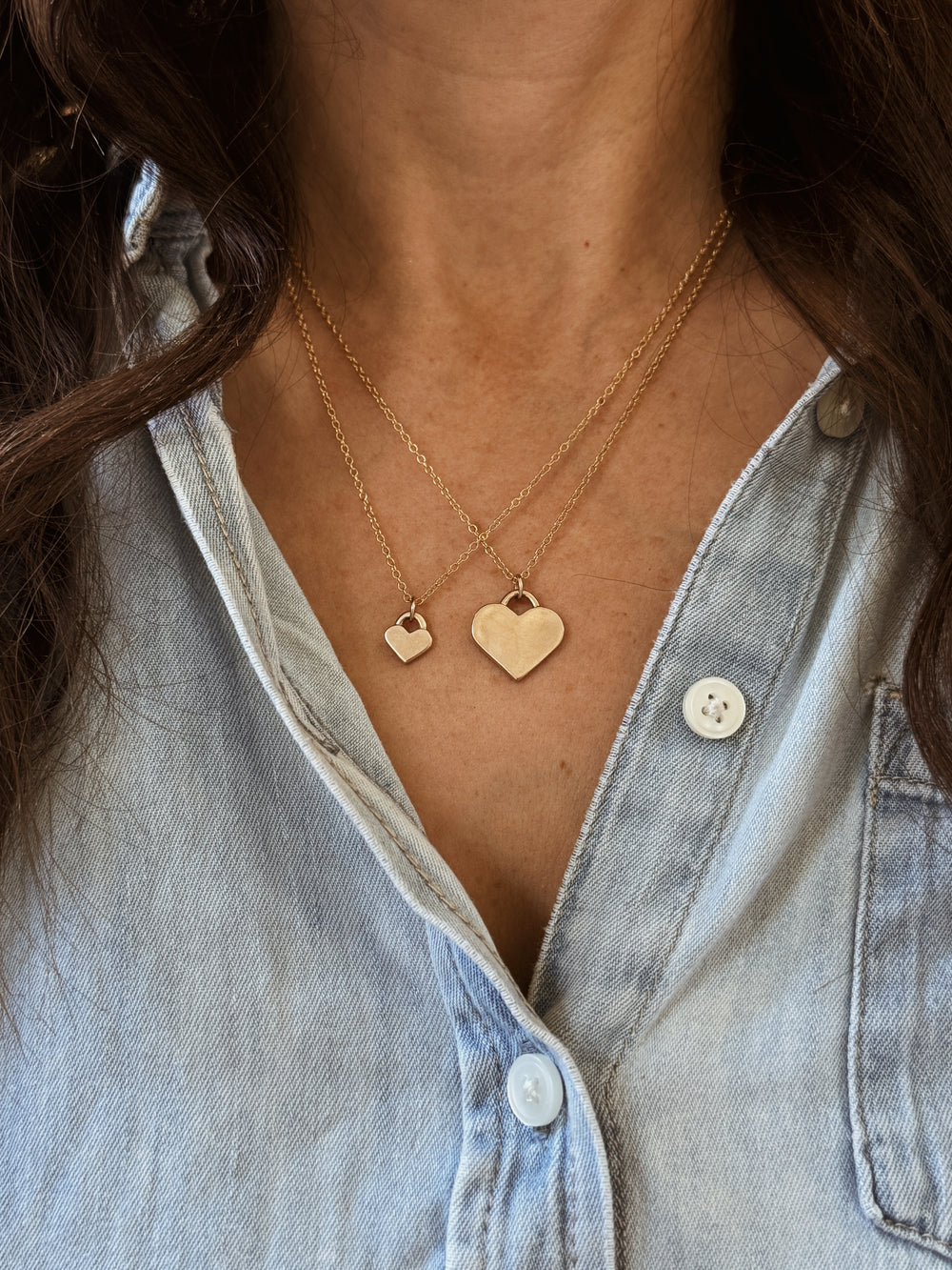 Woman Wears the MIMOSA Handcrafted Large and Small Heart Pendants in Bronze