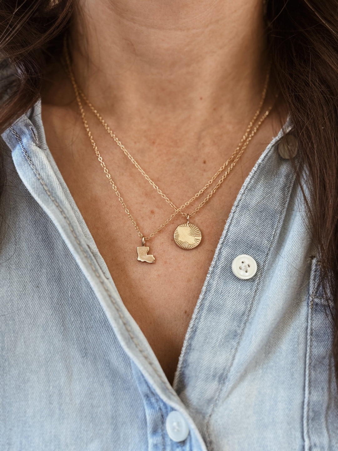 Woman Wears the MIMOSA Handcrafted Louisiana State Pendant and Louisiana Burst Pendant