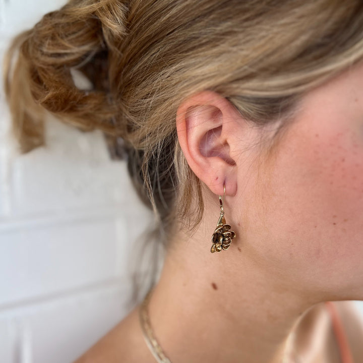 Woman Wears MIMOSA Handcrafted Bronze Magnolia Earrings on Lever-Back Ear Wires.