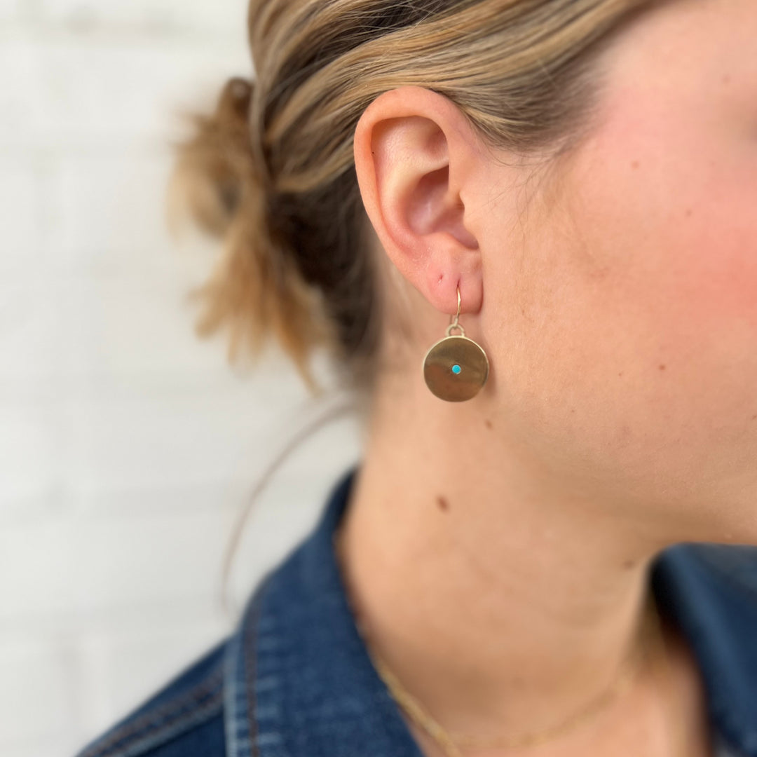 Woman Wears MIMOSA Handcrafted Minimal Circle Stone Earrings in Bronze with Turquoise.