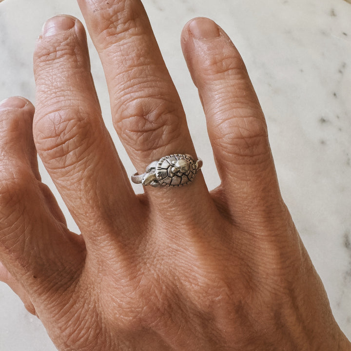 Hand wearing a Mom and Baby Turtle Ring from MIMOSA Handcrafted in sterling silver
