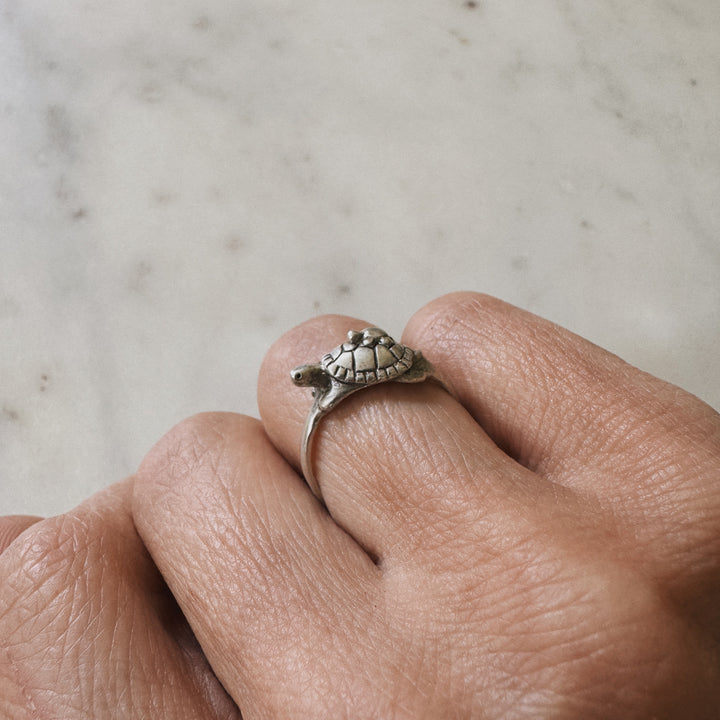 Hand wearing a Mom and Baby Turtle Ring from MIMOSA Handcrafted in sterling silver