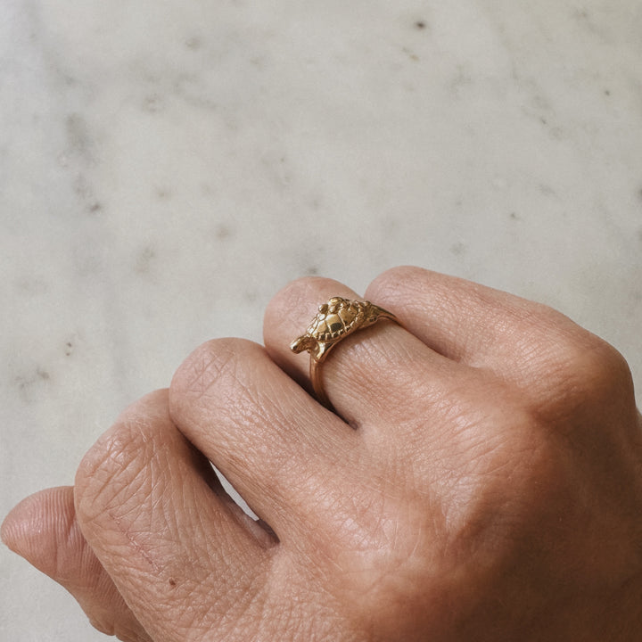 Hand wearing a Mom and Baby Turtle Ring from MIMOSA Handcrafted in bronze
