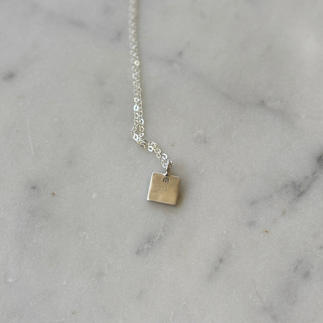 Back of a handmade quilt square necklace in silver by MIMOSA Handcrafted