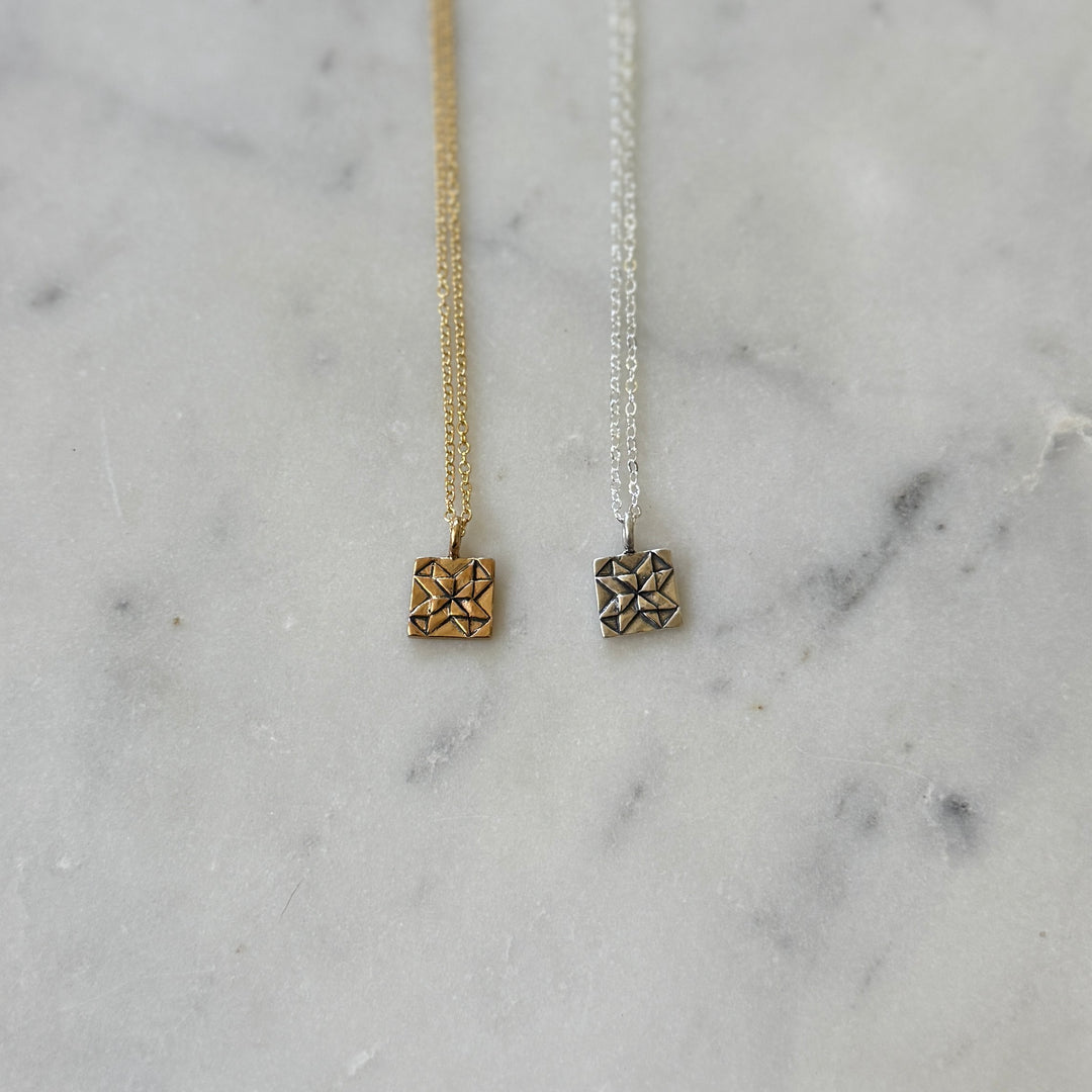 Handmade quilt square necklaces in bronze and sterling silver by MIMOSA Handcrafted