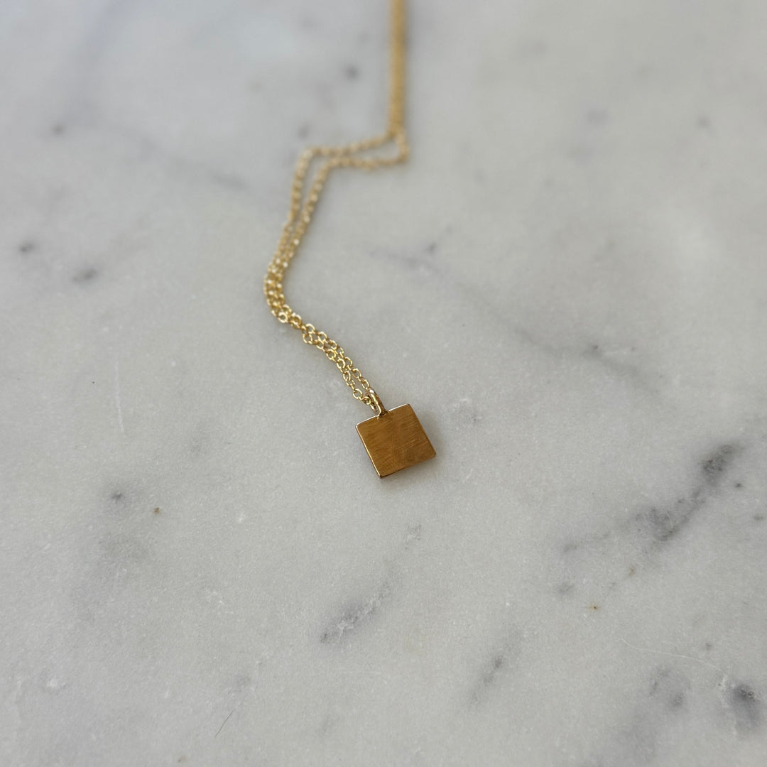 Back of a handmade quilt square necklace in bronze by MIMOSA Handcrafted