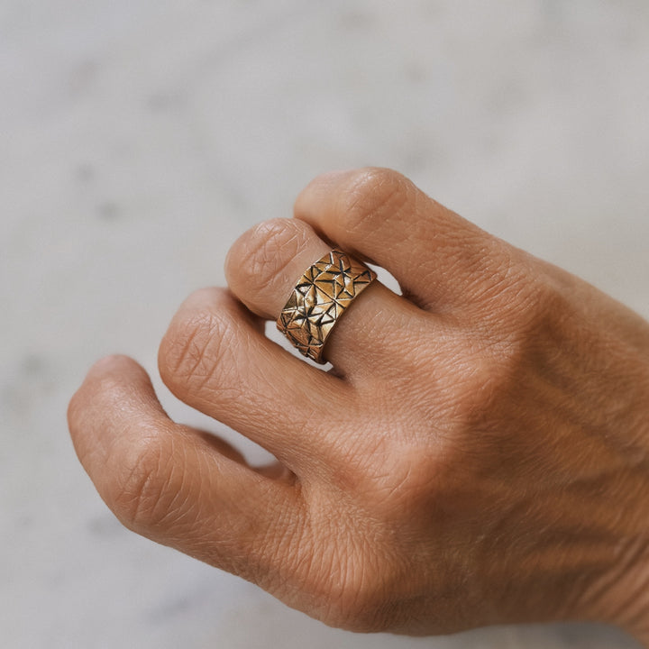 Person wears a handmade quilt square ring in bronze by MIMOSA Handcrafted