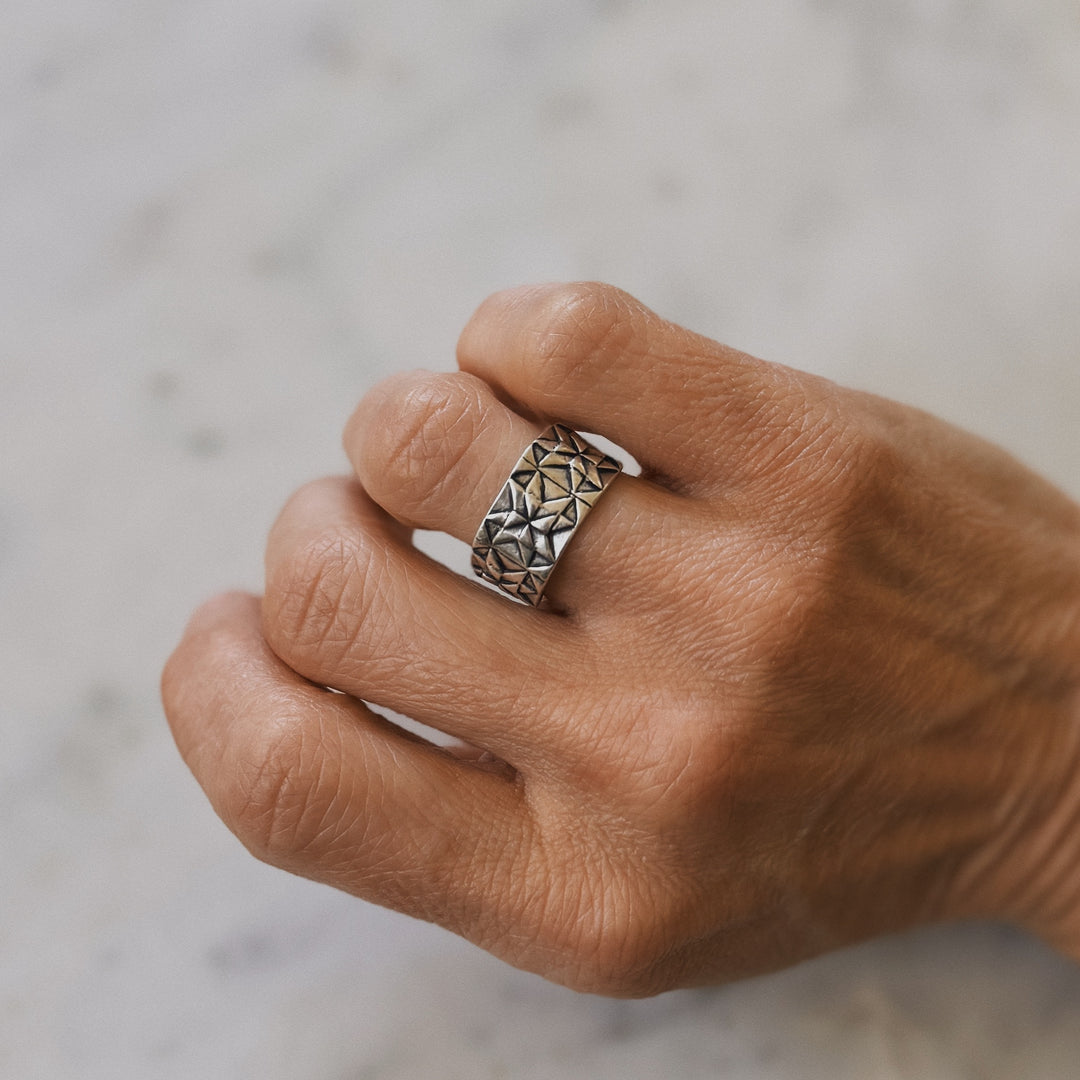 Person wears a handmade quilt square ring in sterling silver by MIMOSA Handcrafted