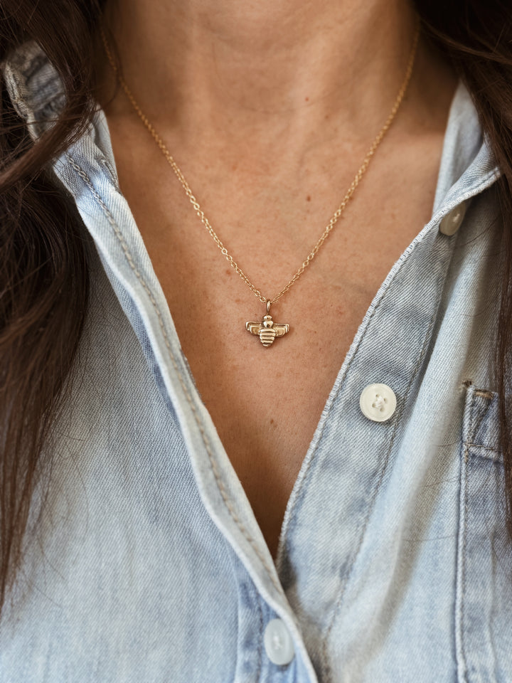 Woman Wears the MIMOSA Handcrafted Small Bee Pendant in Bronze