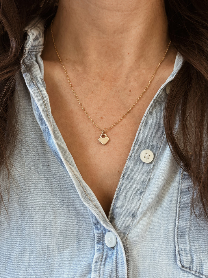 Woman Wears the MIMOSA Handcrafted Small Heart Pendant in Bronze