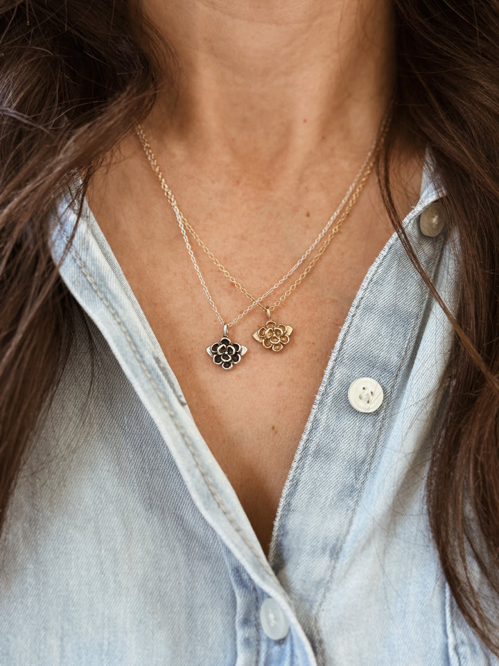 Woman Wears the MIMOSA Handcrafted Small Magnolia Flower Pendants in Bronze and Sterling Silver