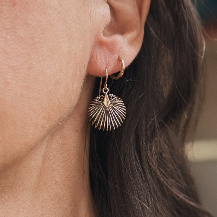 Person wears a Bronze Palmetto Earrings from MIMOSA Handcrafted