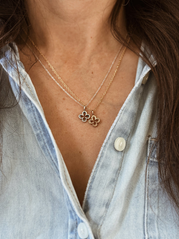 Woman Wears the MIMOSA Handcrafted Small Quatrefoil Pendants in Bronze and Sterling Silver