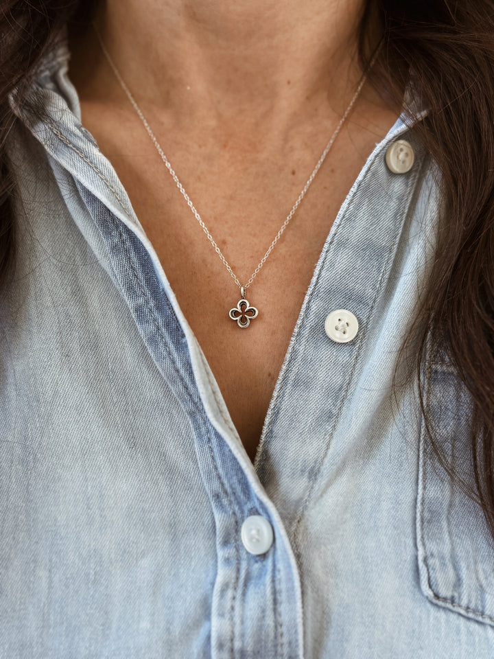 Woman Wears the MIMOSA Handcrafted Small Quatrefoil Pendant in Sterling Silver