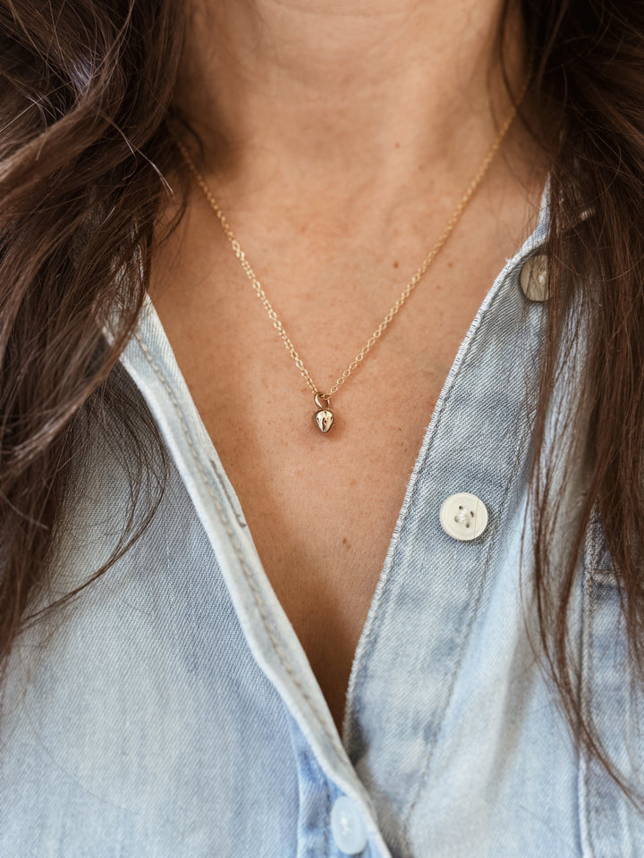 Woman Wears the MIMOSA Handcrafted Small Strawberry Pendant in Bronze