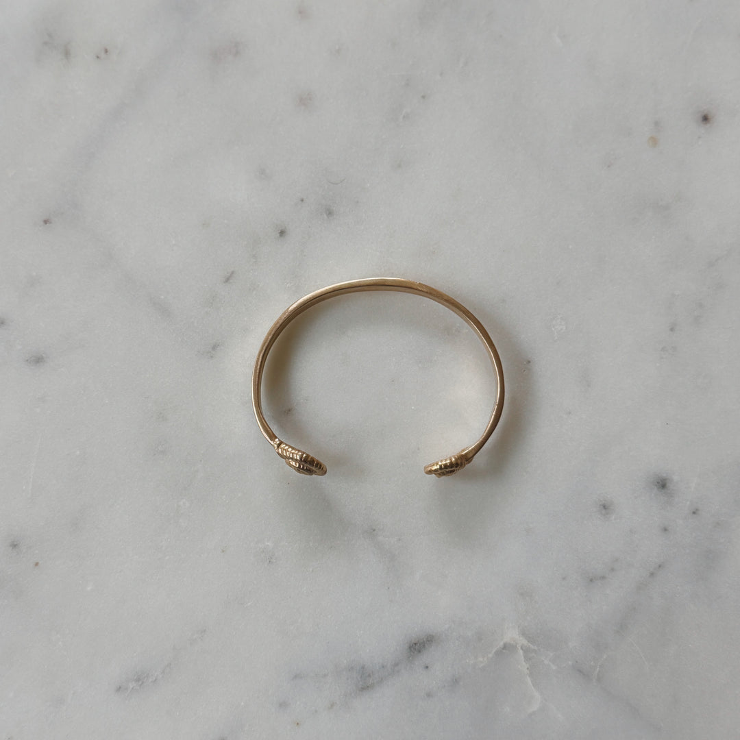 Bronze Bracelet on Marble Surface