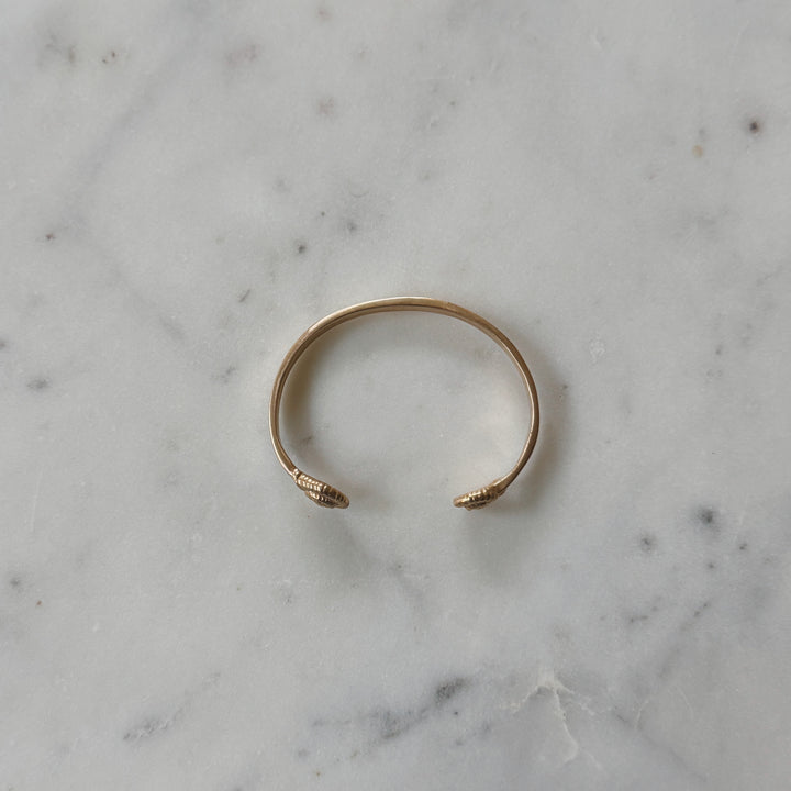 Bronze Bracelet on Marble Surface