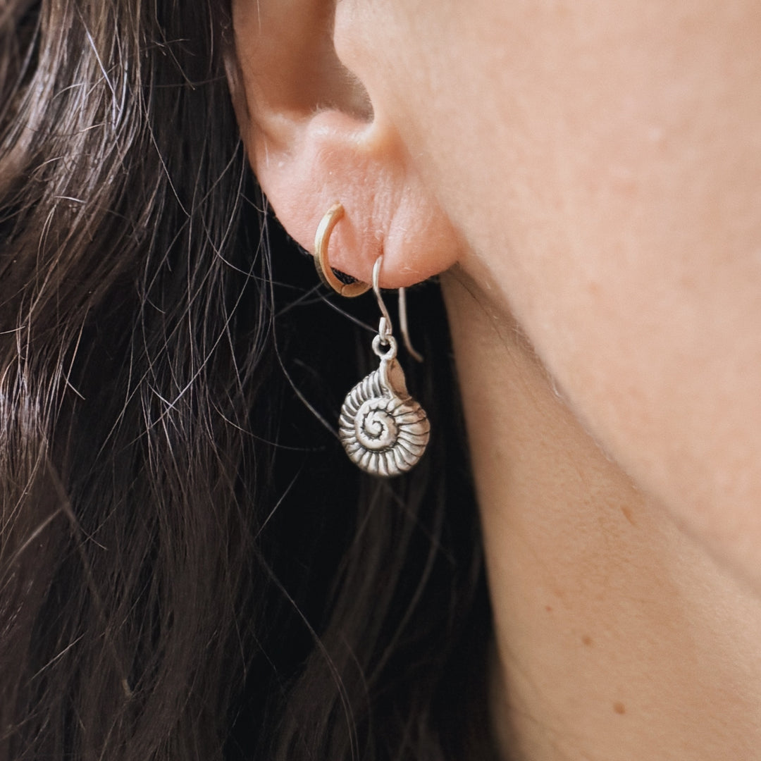 Close Up of a Person Wearing a Sterling Silver Spiral Snail Shell Earring