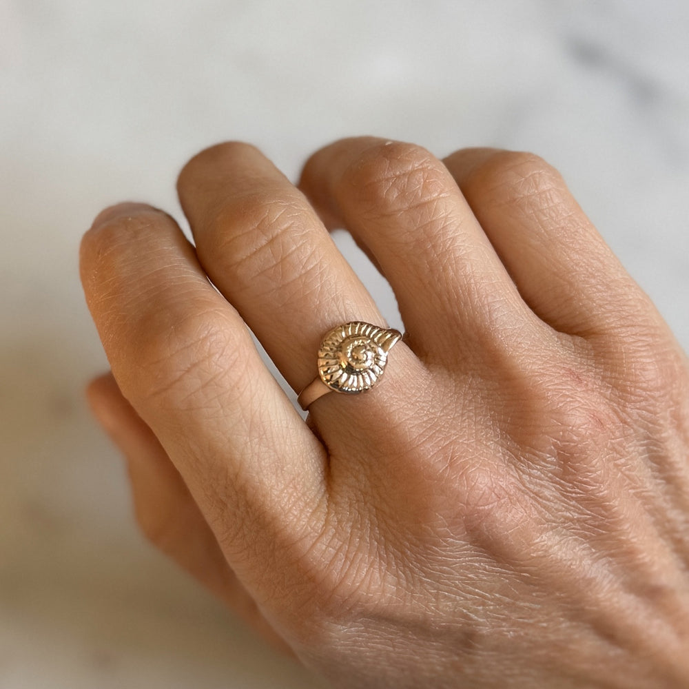 Person Wears Bronze Snail Shell Ring on Middle Finger
