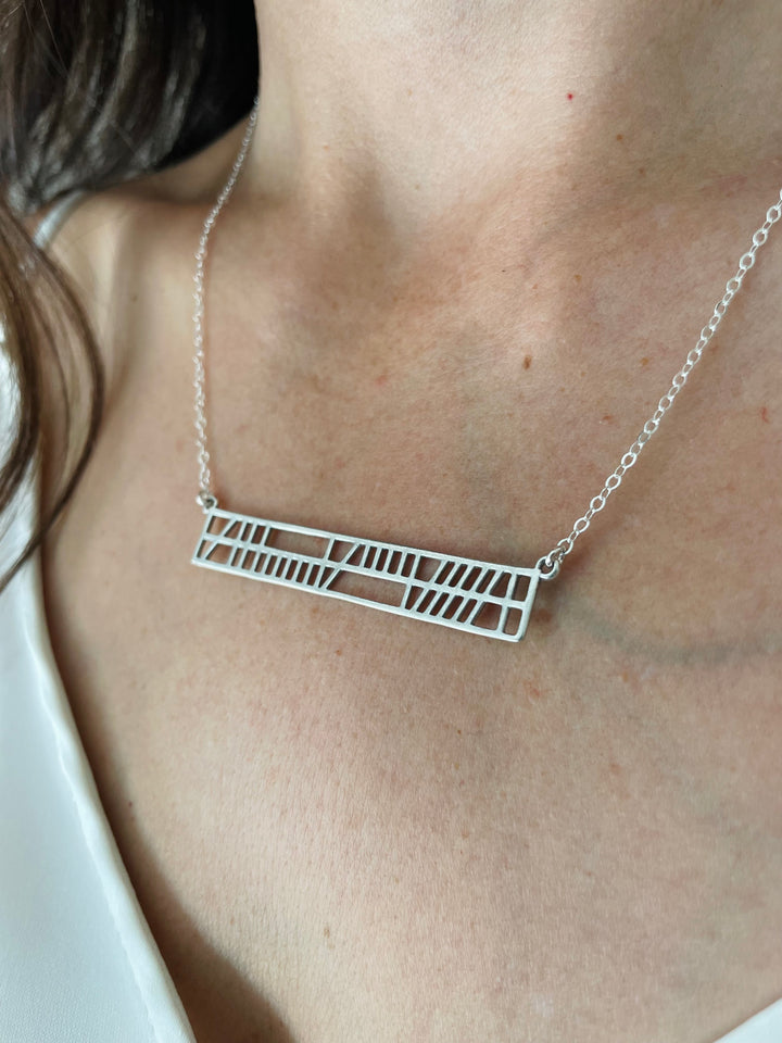 Woman Wearing Handcrafted Gaelic Best Friend Bar Necklace